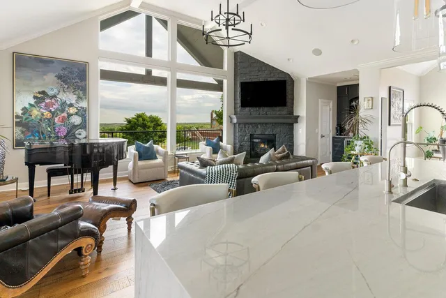 a living room with furniture and a painting on the wall