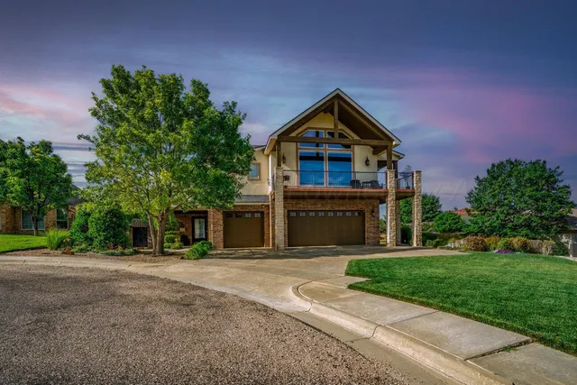 an aerial view of multiple houses with a yard