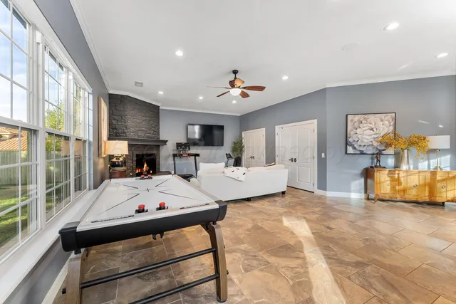 a kitchen with stainless steel appliances granite countertop a sink a stove and white cabinets with wooden floor