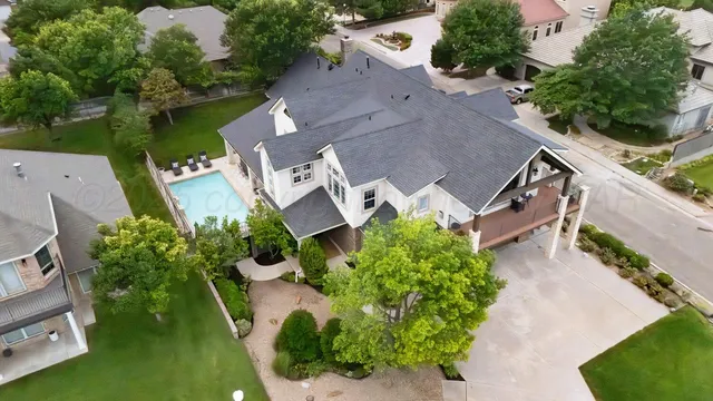 an aerial view of multiple houses with yard