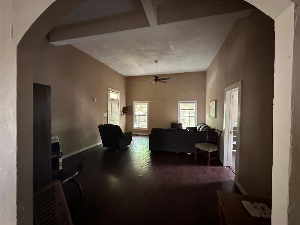 1405 Caddo Street Commerce, TX 75428 - Photo 6 of 8 a view of a livingroom with furniture wooden floor and a window