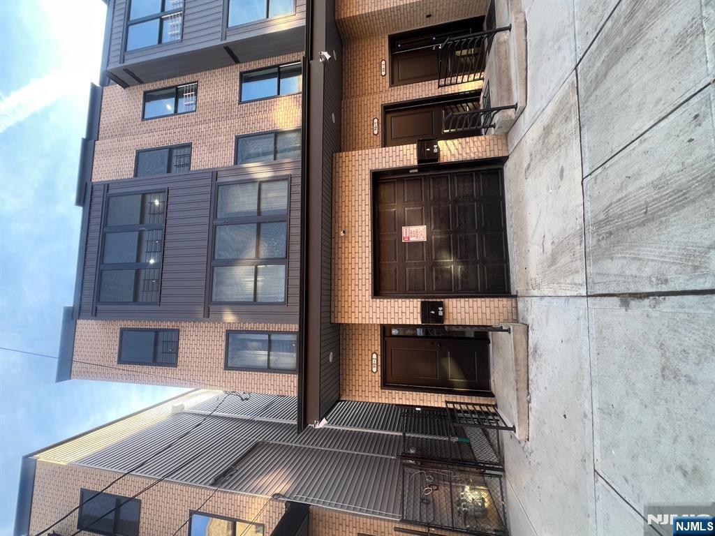 a view of a building with car parked