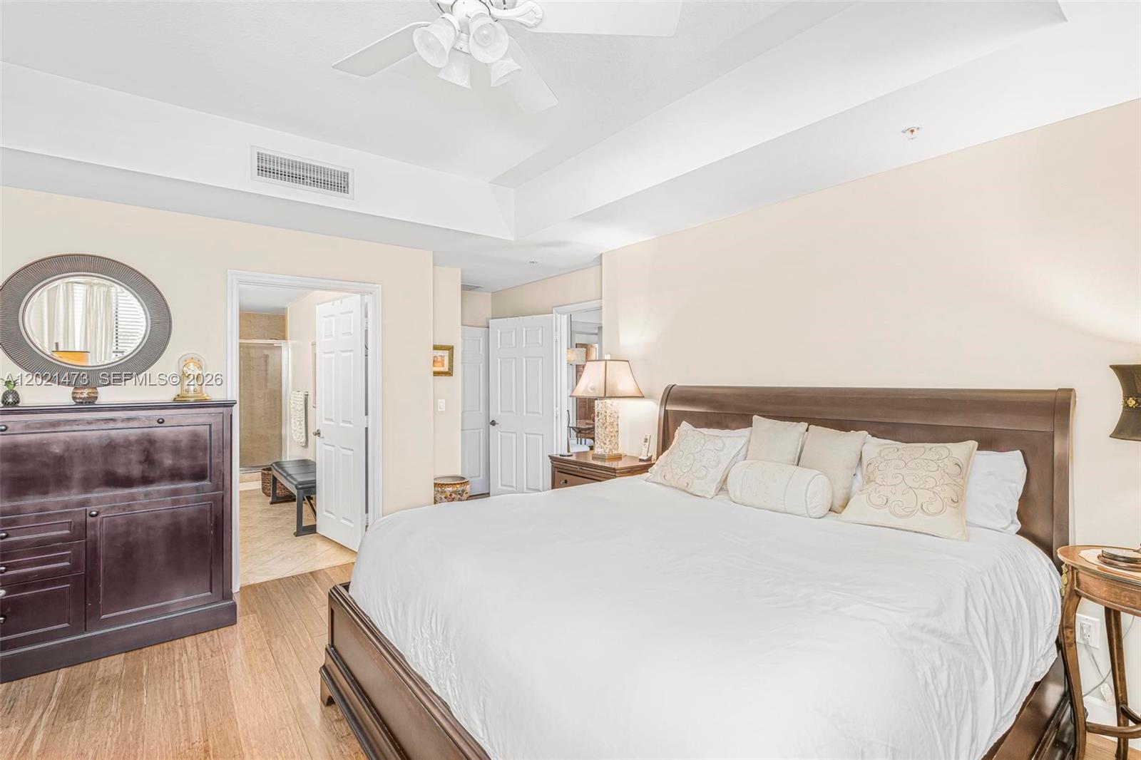 8395 Southwest 73rd Avenue, Unit 710 Miami, FL 33143 - Photo 17 of 32 a bedroom with a bed and a chandelier