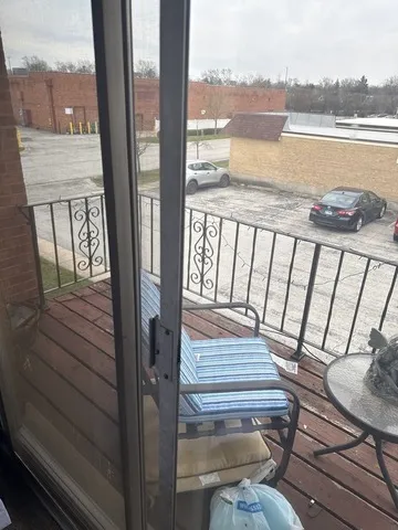 a view of a balcony with lake view and wooden floor