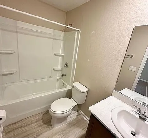 a bathroom with a sink a toilet and a bathtub