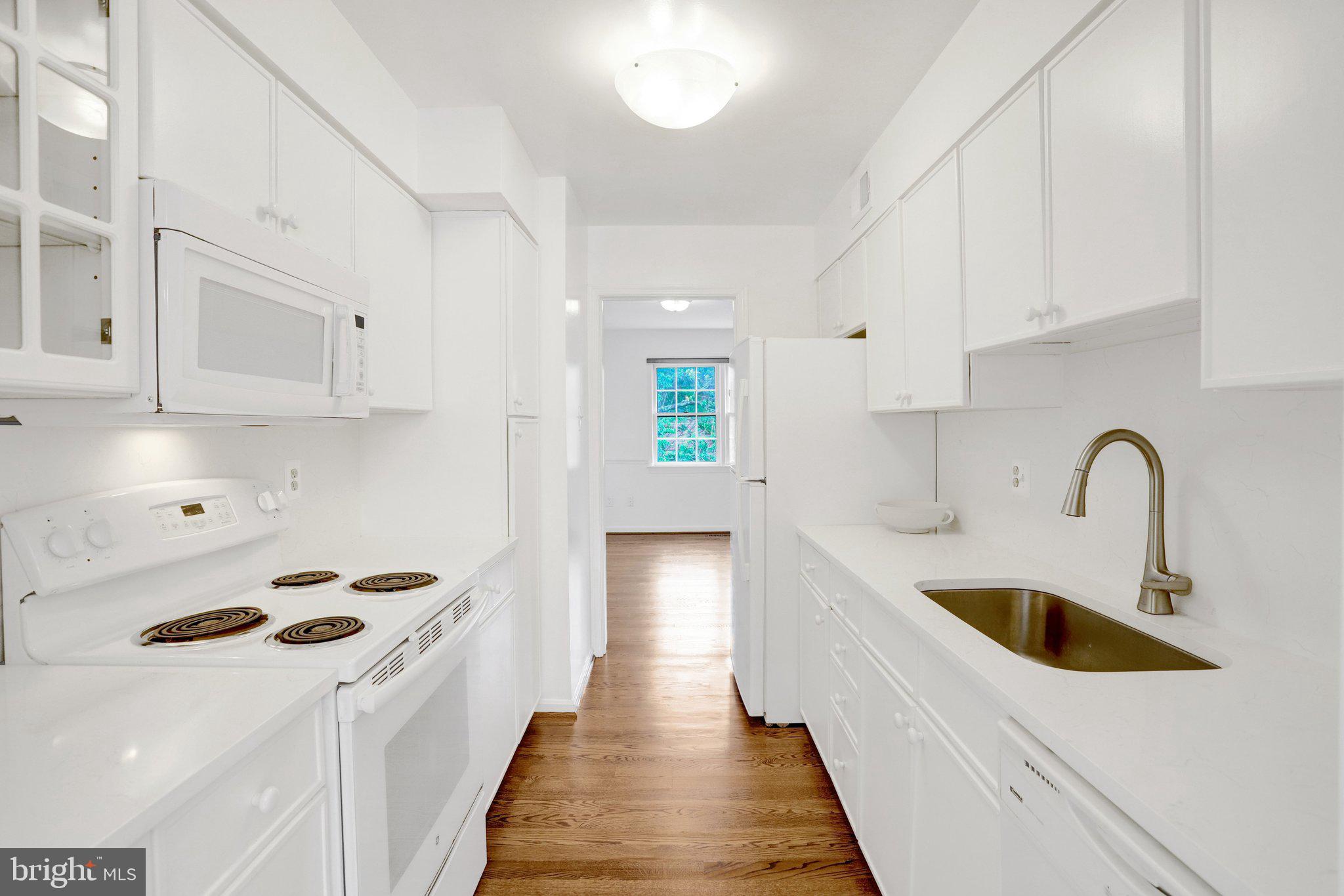 2225 North Tuckahoe Street Arlington, VA 22205 - Photo 10 of 37 a kitchen with kitchen island a white stove top oven sink and cabinets