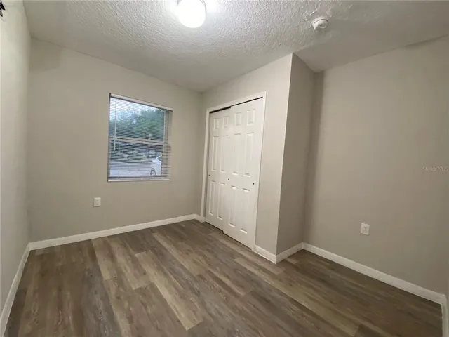 a view of an empty room and wooden floor