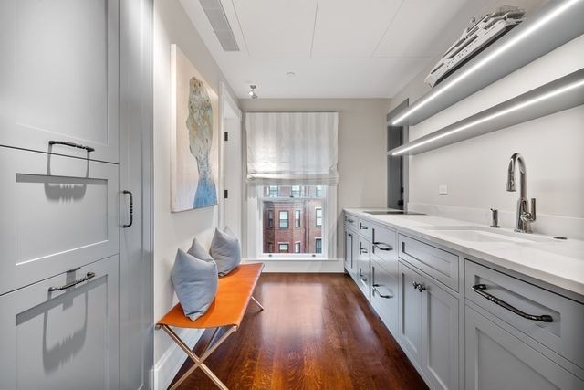 a spacious bathroom with a double vanity sink and a mirror