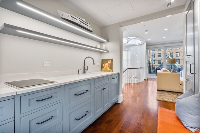 a bathroom with a granite countertop toilet sink and mirror