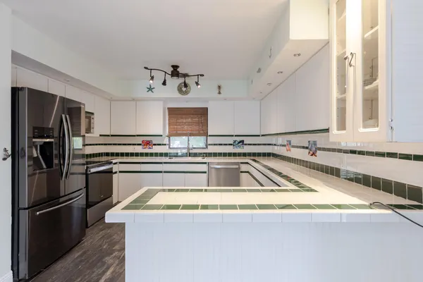 a kitchen with a refrigerator and a sink