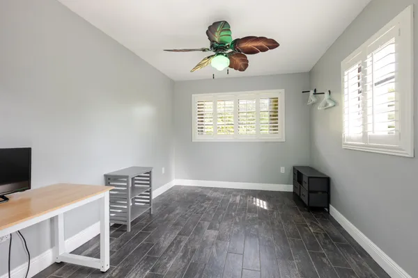 a view of workspace with wooden floor and windows