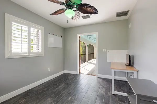 a view of a workspace with furniture and a window