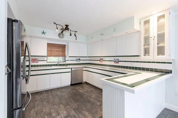 a kitchen with a stove a sink and a refrigerator