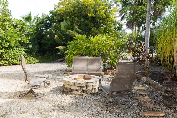 a view of a backyard with table and chairs and potted plants