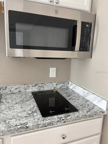 a bathroom with a sink and granite counter top