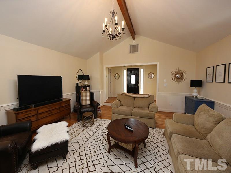 11908 Old Creedmoor Road Raleigh, NC 27613 - Photo 3 of 16 a living room with furniture and a flat screen tv