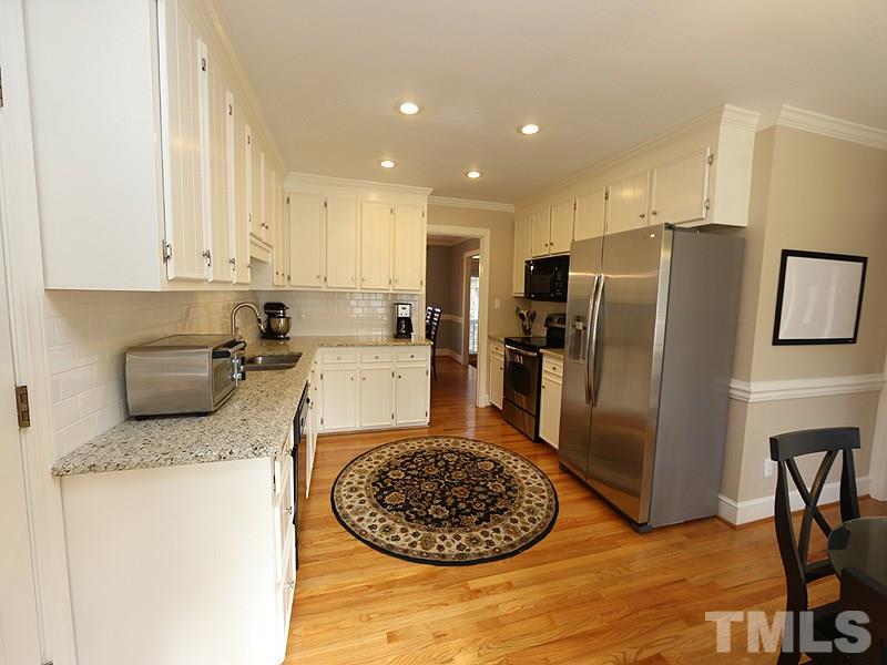 11908 Old Creedmoor Road Raleigh, NC 27613 - Photo 5 of 16 a kitchen with refrigerator and stove