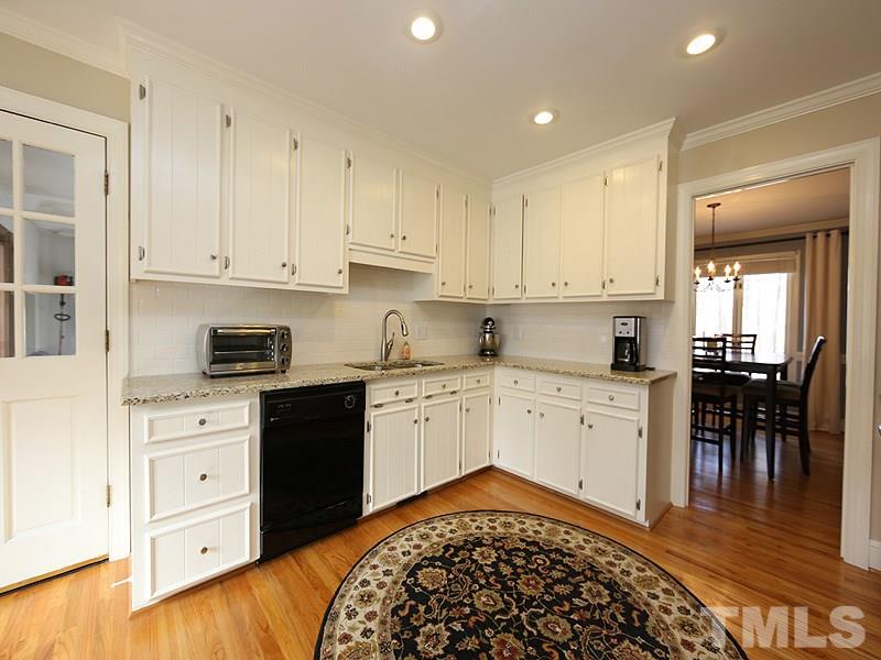 11908 Old Creedmoor Road Raleigh, NC 27613 - Photo 6 of 16 a kitchen with granite countertop white cabinets and white appliances