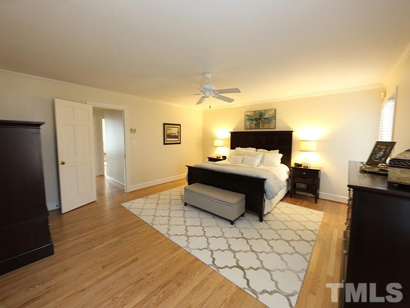 11908 Old Creedmoor Road Raleigh, NC 27613 - Photo 8 of 16 a bedroom with a bed and wooden floor