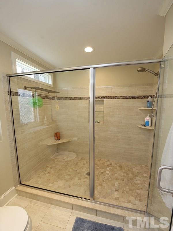 11908 Old Creedmoor Road Raleigh, NC 27613 - Photo 10 of 16 a bathroom with a glass shower door