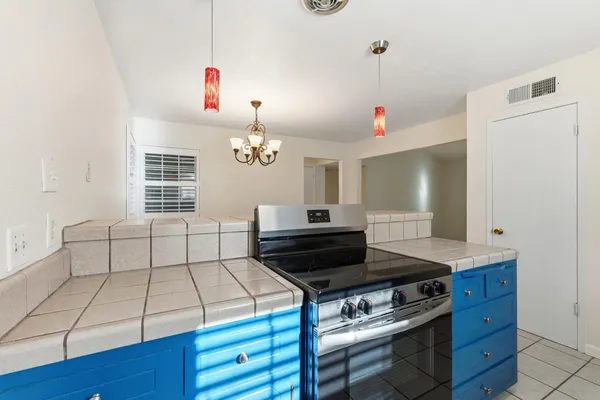 a kitchen with a stove and white cabinets