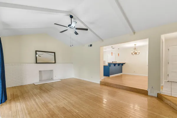 a bedroom with a bed and painting on the wall