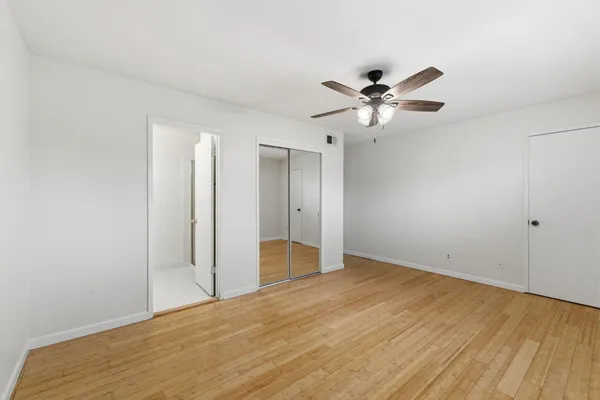 an empty room with fan and a ceiling fan