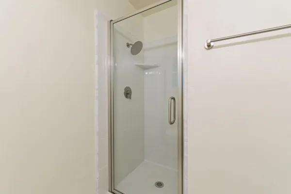 a bathroom with a glass shower door