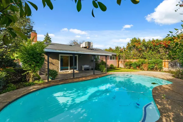 a view of a house with swimming pool and sitting area