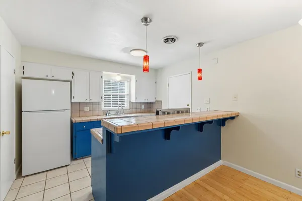 a kitchen with stainless steel appliances granite countertop a sink and a refrigerator