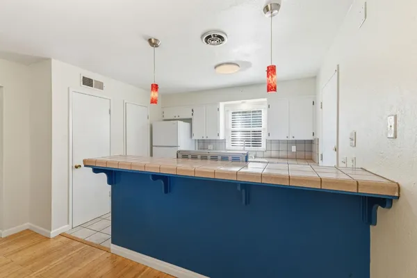a kitchen with granite countertop a sink and cabinets