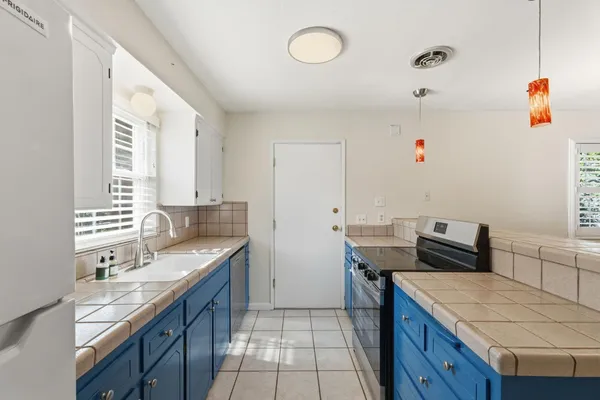 a kitchen that has a sink and a stove in it