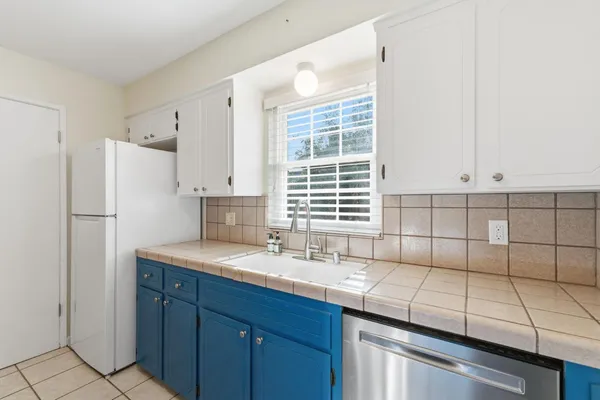 a kitchen with a sink cabinets and window