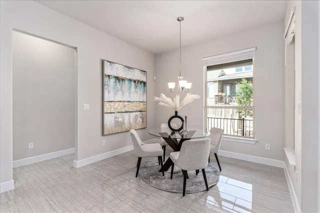 a dining room with furniture a chandelier and wooden floor