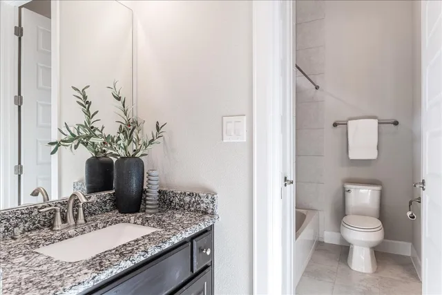 an empty room with chandelier fan and windows