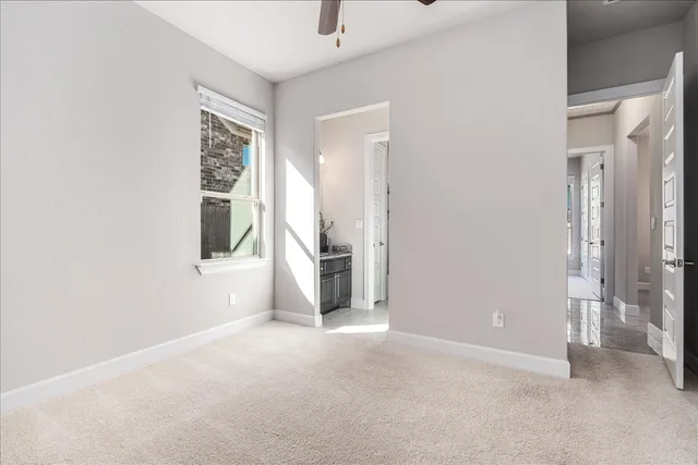 a bathroom with a granite countertop sink a toilet and a mirror