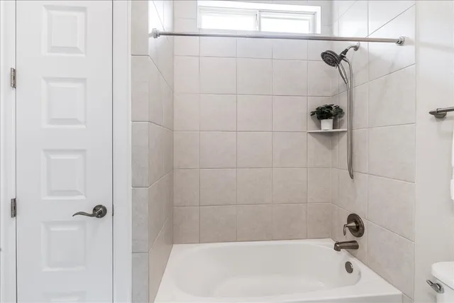 a bathroom with a granite countertop sink a mirror and a bathtub