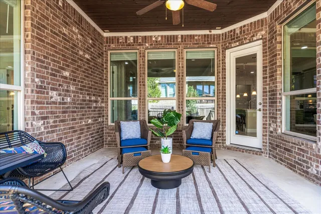 a living room with patio furniture and a potted plant