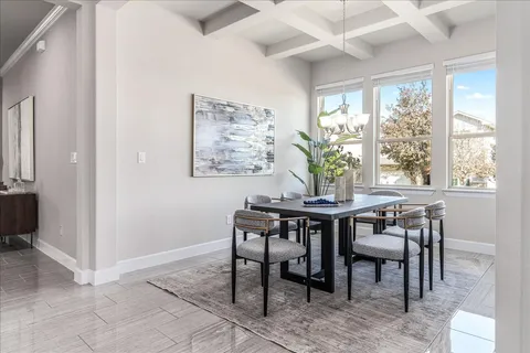 a view of a dining room with furniture wooden floor and chandelier