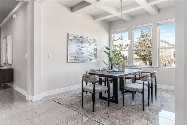 a view of a dining room with furniture wooden floor and chandelier