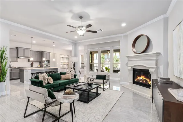a living room with furniture a fireplace and a large window
