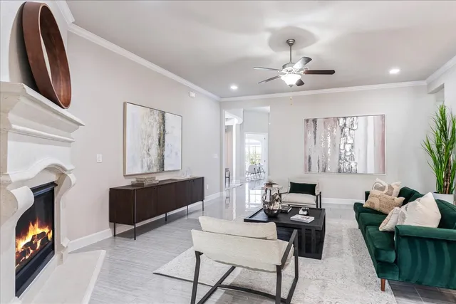 a living room with furniture a fireplace and a flat screen tv