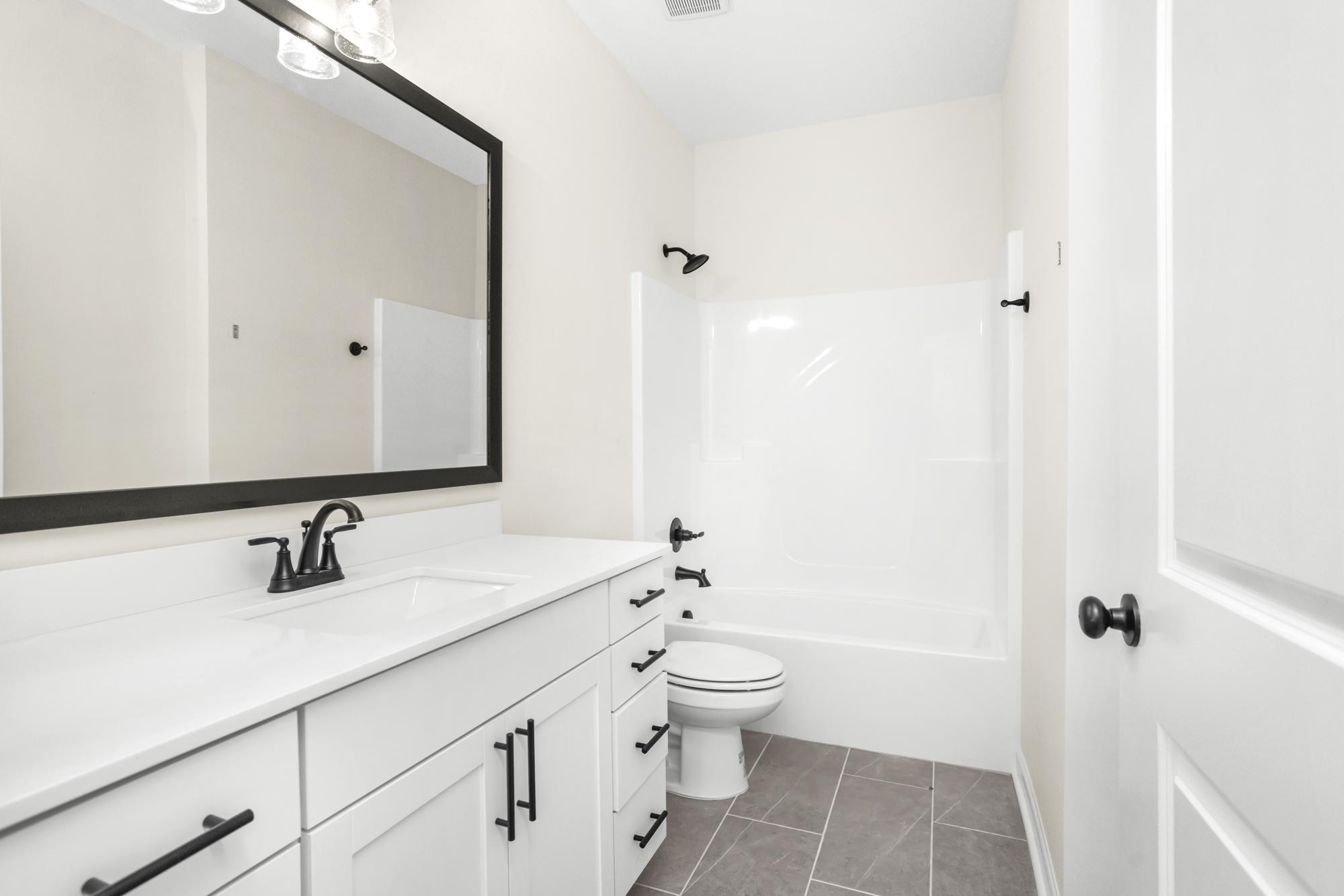 4014 Rampart Way Spring Hill Spring Hill, TN 37174 - Photo 12 of 48 a bathroom with a sink a toilet and a large mirror