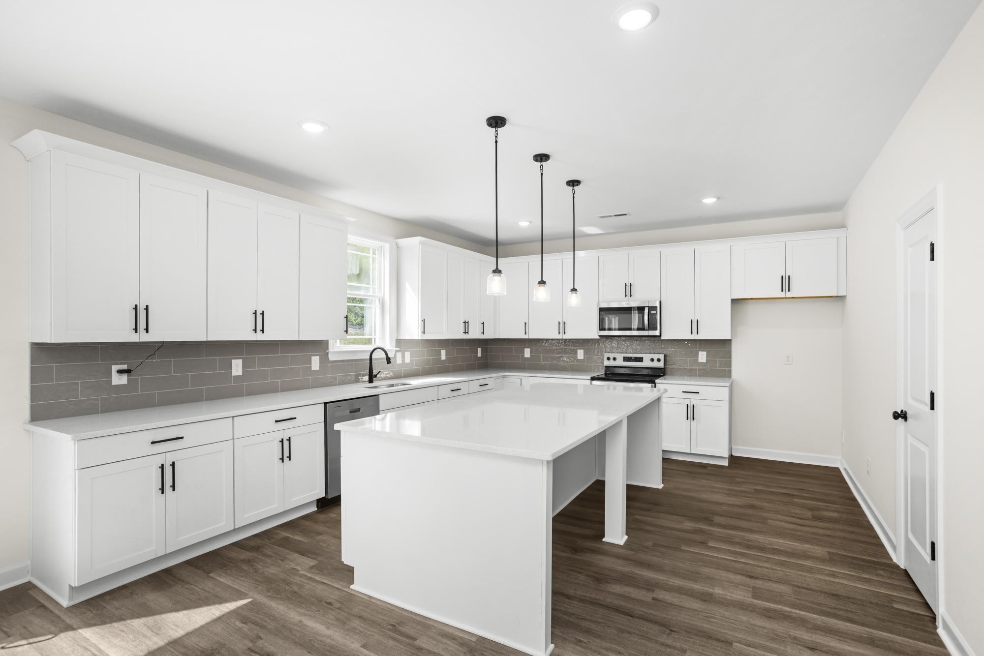 4014 Rampart Way Spring Hill Spring Hill, TN 37174 - Photo 13 of 48 a kitchen with a sink a stove a refrigerator and white cabinets