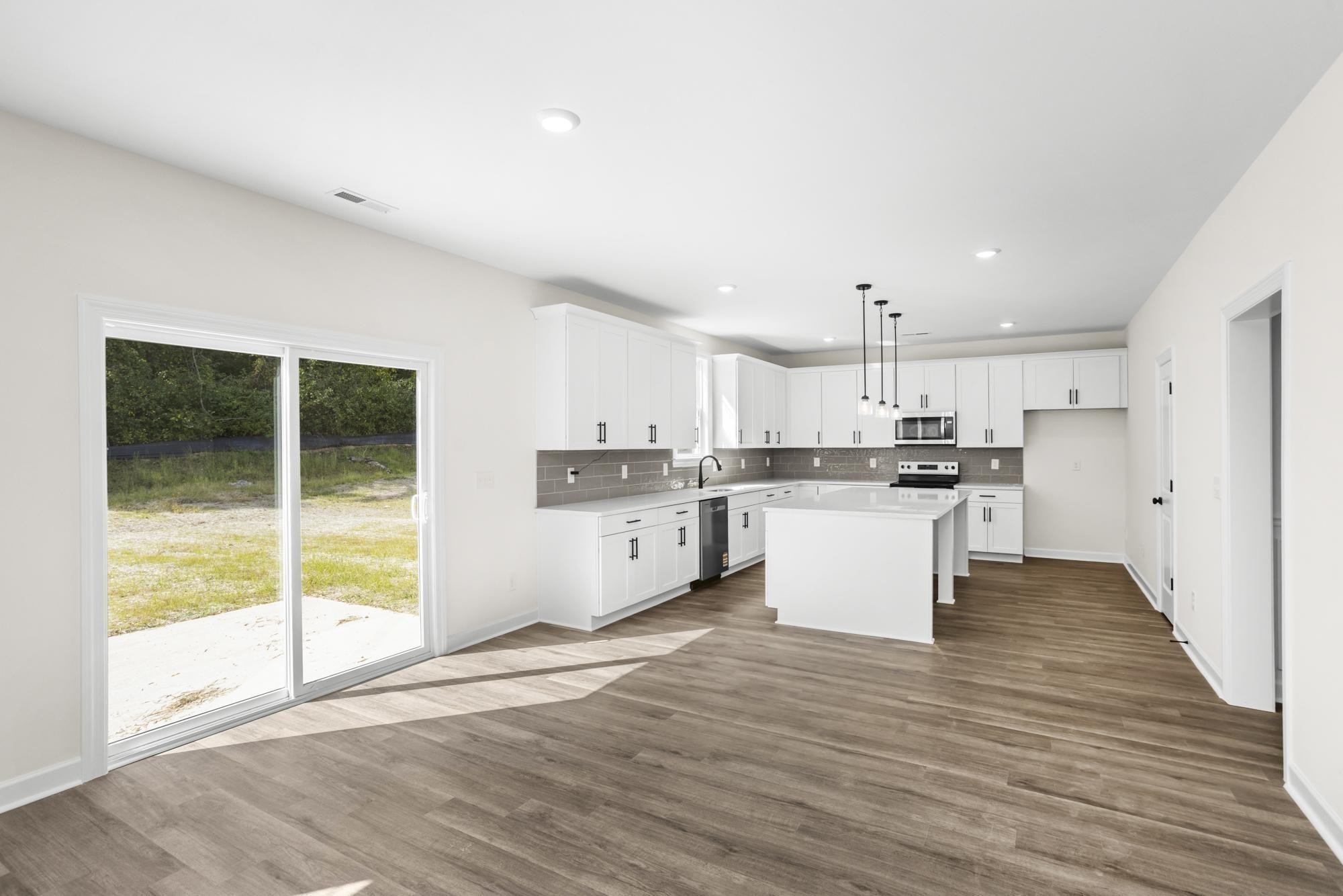 4014 Rampart Way Spring Hill Spring Hill, TN 37174 - Photo 15 of 48 a view of kitchen with granite countertop a stove top oven a sink and white cabinets
