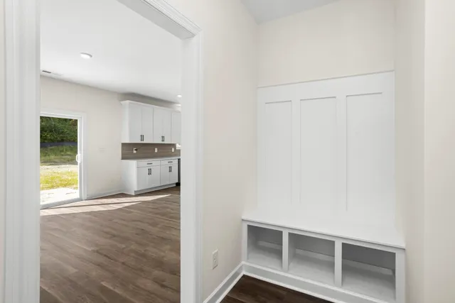 a view of a hallway with wooden floor