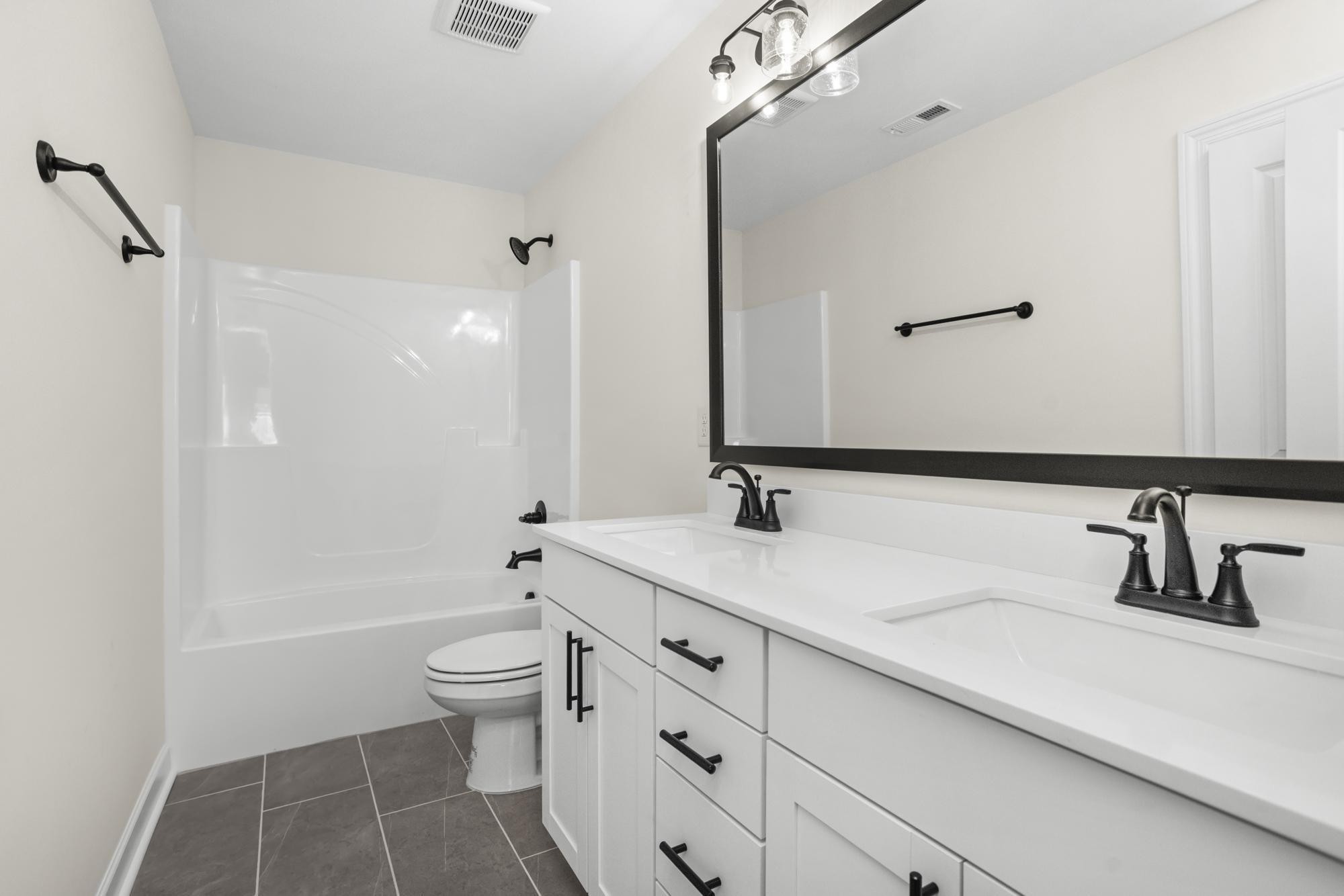 4014 Rampart Way Spring Hill Spring Hill, TN 37174 - Photo 30 of 48 a bathroom with a double vanity sink toilet and shower