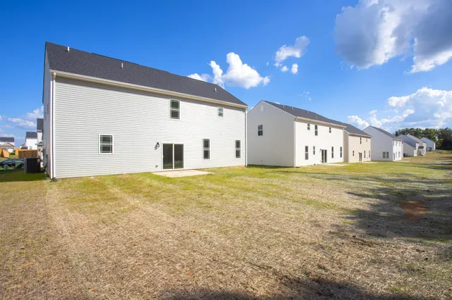 a view of a house with a backyard