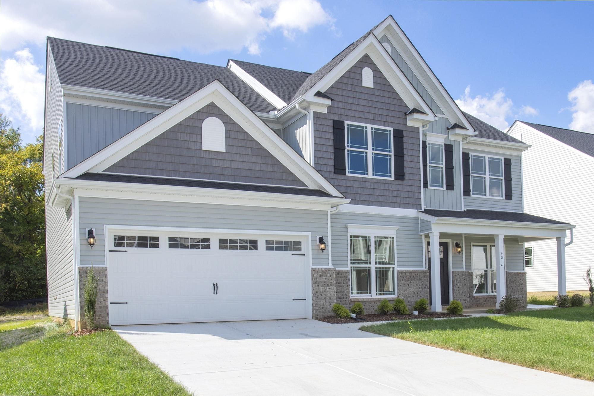 4014 Rampart Way Spring Hill Spring Hill, TN 37174 - Photo 5 of 48 a front view of a house with a garden and plants