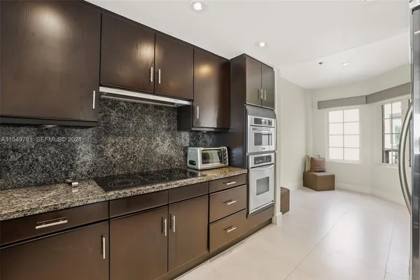 a kitchen that has a sink and a stove